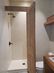 Sylvia T Designs – Another example of an all-over tadelakt plaster finish in a residential bathroom in New Orleans. You can see the wet application in the shower – this special plaster is water and mold resistant – as well as the dry application outside the shower. Different numbers of coats and impeccable timing are required to not only effectively make the plaster moisture resistant but also to properly match the look, feel, and color across both the wet and dry applications.