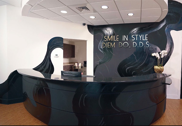 Sylvia T Designs – Patients at this New Orleans area dentist office, located in Marrero, are greeted by this gorgeous, flowing reception desk and branded feature wall!