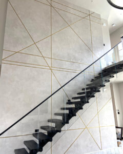 Sylvia T Designs – A new construction, residential project in the Lakeview neighborhood of New Orleans. This stunning feature wall in the living area boasts a beautiful gloss plaster finish and metal inlays. It’s a showstopper!