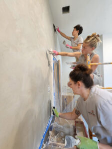 The Sylvia T Designs team applying Tadelakt plaster to a residential shower.